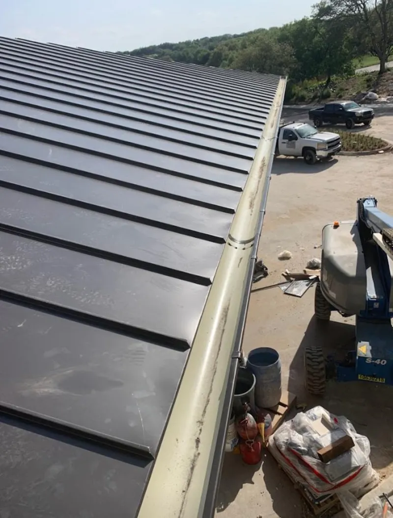Standing seam panel and gutter detail on a metal roofing jobsite in Ogden
